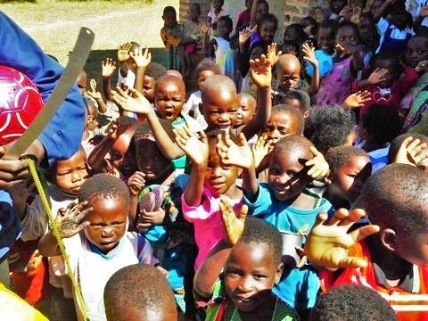 Malawi kindergarten children waving to donors from Australia