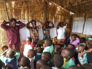 enthusiastic teachers and students learning songs in english and chichewa answering the question why kindergarten